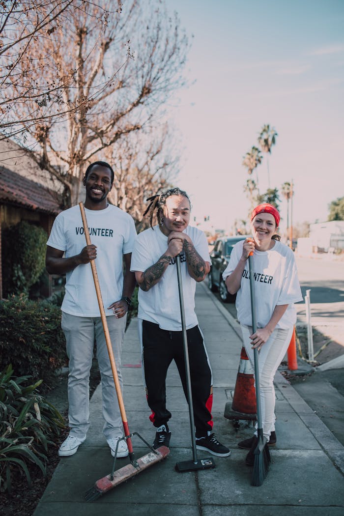 Photo of People Holding Broomsticks
